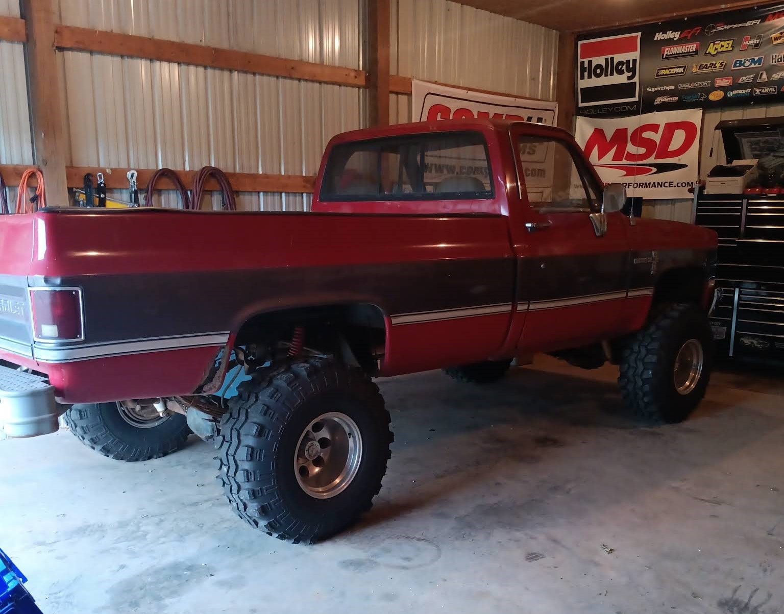 Lifted Chevy K10 truck in the Buffalo Repair shop bay